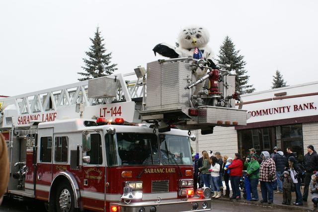 Sara the Snowy Owl waves to crowd atop of Ladder 144, Winter Carnival 2012